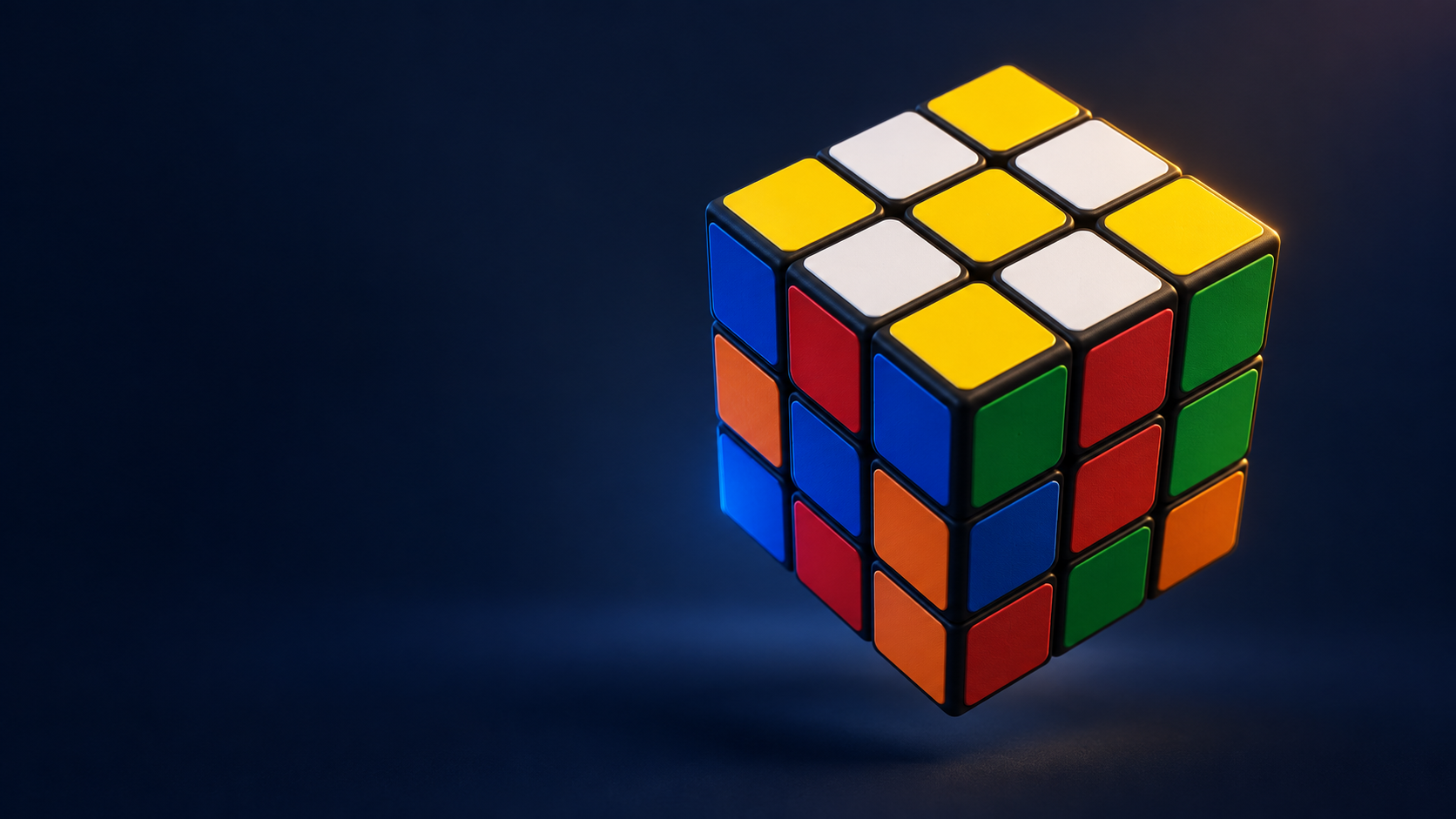 A 3×3 cube on a navy background with yellow facing up and white edge pieces around the yellow center